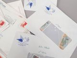 many different types of letters and envelopes laid out on the table