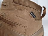 a close up of a pair of tan hiking boots on a white background