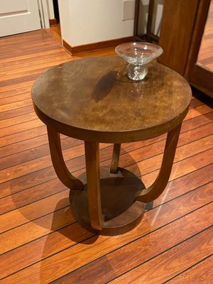 a small table with a bowl on it on a wooden floor