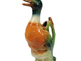 a figurine of a duck on a white background