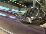 a close up of a car ' s side mirror with a sticker on it