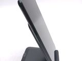 a cell phone that is sitting on top of a stand