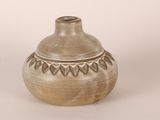 a small vase that is sitting on a white surface