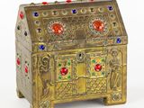 an image of a gold chest with colorful stones on it