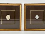 pair of antique gold frames with a roman coin in the middle