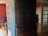 a wooden cabinet in the middle of a living room