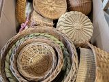 a box full of wicker baskets sitting on the floor