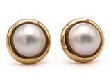 a pair of pearl earrings on a white background