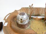 a metal tray with a metal object on top of it