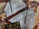 a painting of a pair of scissors and a book on a table