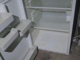 an empty refrigerator with its door open in the kitchen