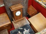 a table with a clock and many other items on it