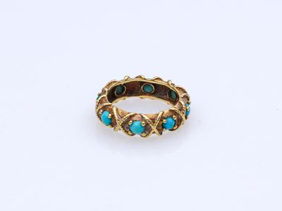 a gold ring with turquoise stones