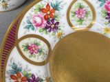 two cups and a saucer sitting on a table