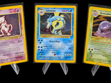 three different pokemon cards are displayed on a black background