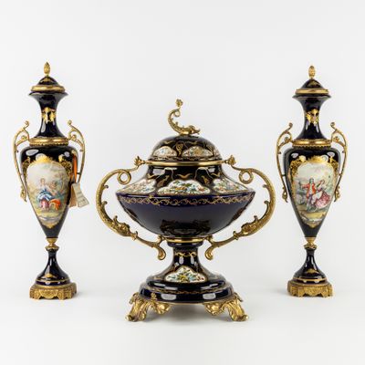 two vases and a bowl are sitting on a white surface