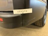 the rear end of a car with a sticker on it