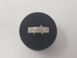 a close up of a diamond ring on a black ring holder