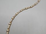 a gold and diamond necklace on a white background