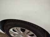 a close up of a tire on a white car