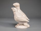 a white bird that is sitting on top of a table