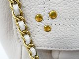 a close up of a white purse with a face on it