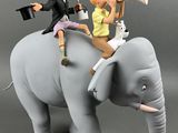 a figurine of a man riding an elephant with a woman on it