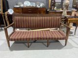 a couch with a baseball bat on it in a room