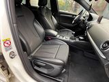 the interior of a car with the door open and the driver ' s seat down