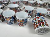 many cups and saucers sitting on a table