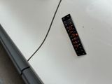 a sticker on the side of a white car