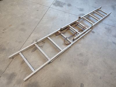 a ladder laying on the floor in a garage