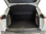 a trunk of a white car with its doors open