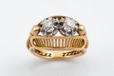an image of a gold ring with two diamonds on it