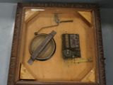 a picture of a wooden frame with a clock and a magnifying glass