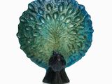 statue of a peacock on a pedestal with a white background