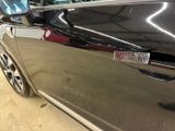 a close up of a car door with a sticker on it