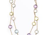 a necklace with multi colored stones and gold chains