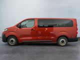 the red van is parked in a parking lot on a cloudy day