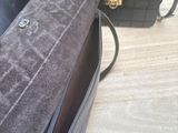 two purses that are sitting on a wooden table