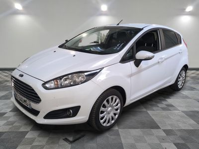 the white ford fiesta is parked in a room with a checkered floor