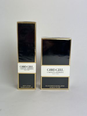a couple of boxes of perfume sitting on top of a white surface