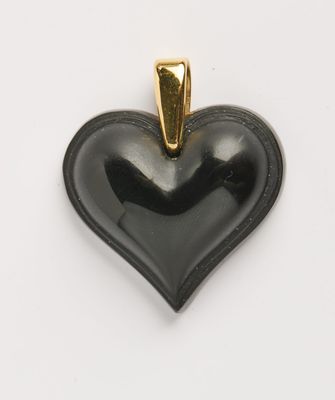 une image représentant un pendentif noir en forme de cœur sur fond blanc