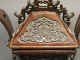 a very ornate wooden table with two chairs in it