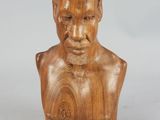 an image of a wooden bust of a man on a white background