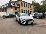 a white car parked in front of a building