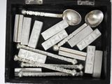 many silver spoons and spoon spoons in a black box