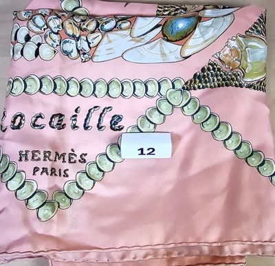 a pink scarf with a picture of a woman ' s necklace on it
