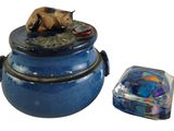 a blue container with a bear on it and a glass container with a lid