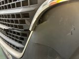 a close up of the front of a car with a grill